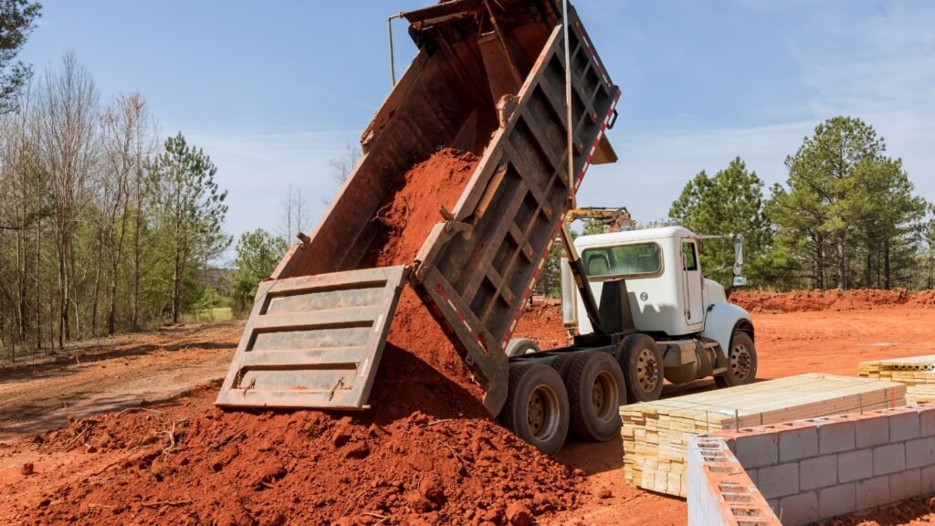 Professional excavation contractor dump truck delivering dirt in Clark County