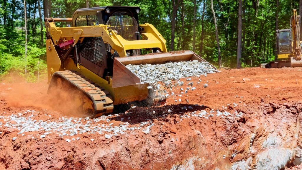 Excavation contractor using skid steer to dump rock in Jeffersonville Indiana